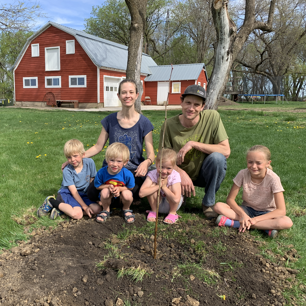 Smiling Tree Toys family planting trees with each purchase