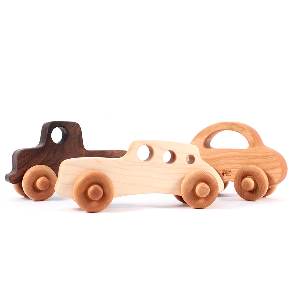 three wooden toy cars